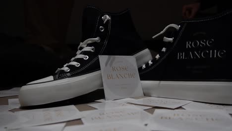 stylish sneakers inspired by the classic converse design, featuring a delicate white rose motif. perfect for fashion, urban lifestyle, and creative design projects blending streetwear with elegance.