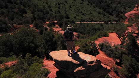 Aerial-of-two-lovers-couple-standing-on-red-peak-butte-near-Sedona-Arizona-1