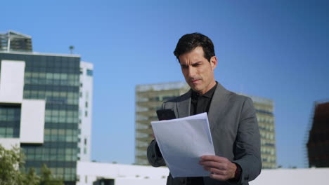 Businessman-working-with-papers-outdoors.-Entrepreneur-taking-photo-of-documents