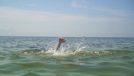 hands of a drowning man in the sea 02