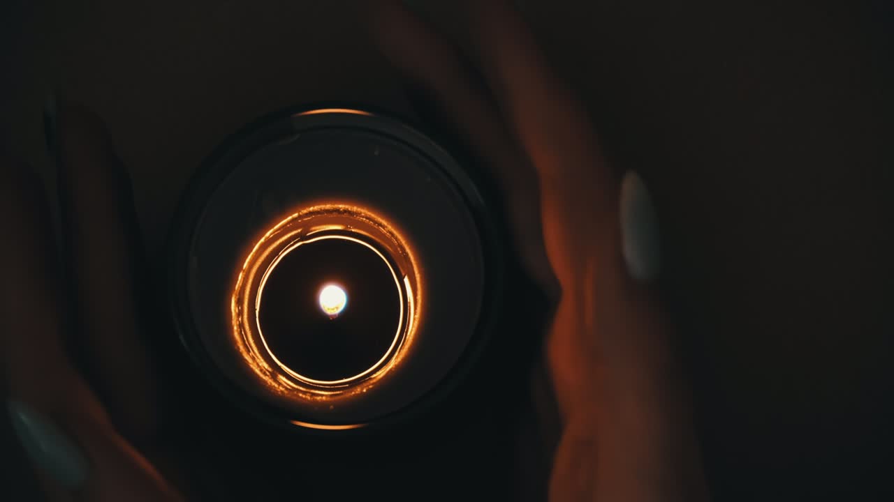 Candle Burns Atmospherically in the Hands of a Girl with a Beautiful Manicure
