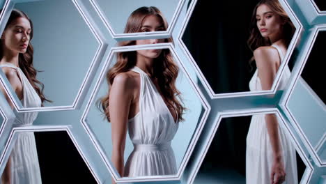 woman in white dress reflected in hexagonal mirrors