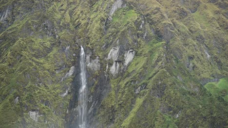 big waterfall falling down a mountain in rugged rocky himalayas mountains scenery in the annapurna region of nepal