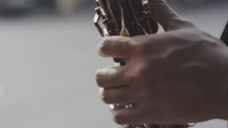 man playing saxophone on the street