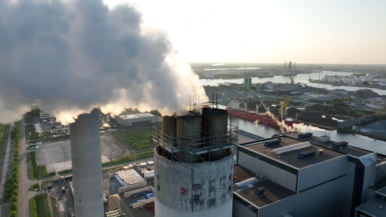 Close up view on smoking, steaming, chimney, industrial facility, factory, carbon emission, heavy industry. Industrial waste. Aerial close up view.