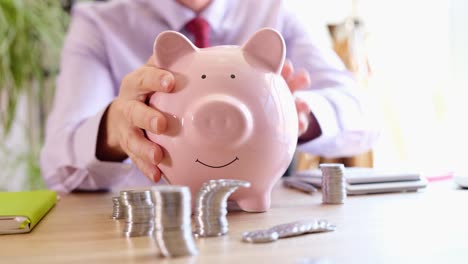 Man saving money with piggy bank
