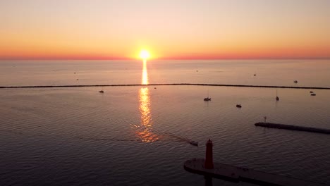 sun setting over the muskegon channel and lake michigan