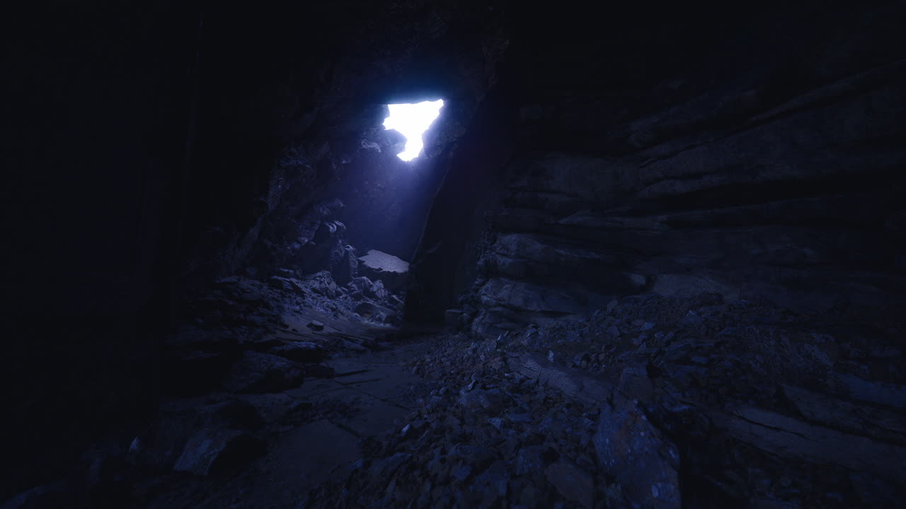 Sottile bagliore osservato attraverso un'apertura in una caverna oscura.