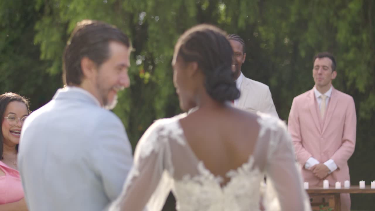 Outdoor Wedding Ceremony with Bride, Groom, and Guests