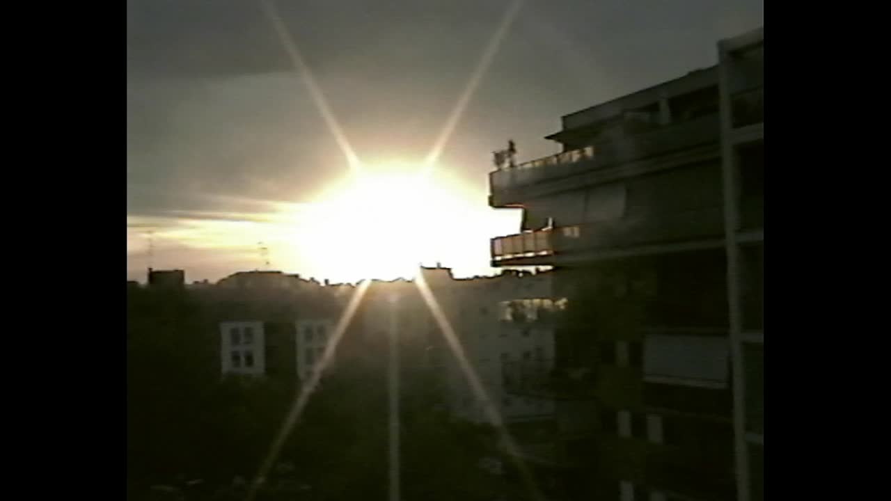 Sunset view behind city buildings in VHS aesthetic