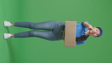 woman delivery person holding a box, pointing and looking disappointed