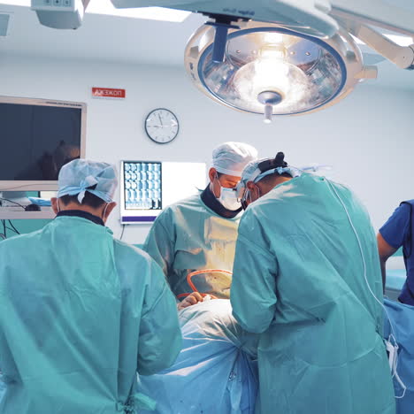 operation room with specialists. teamwork of surgeons performing operation on the background of modern equipment in private clinic.
