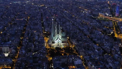 aerial view of barcelona eixample residential district and famous basilica sagrada familia during blue hour. catalonia, spain