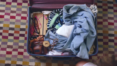 Top-view-packing-vintage-suitcase-girls-planning-road-trip