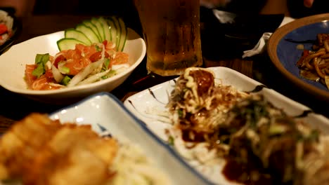 chopsticks picking takoyaki at a japanese restaurant