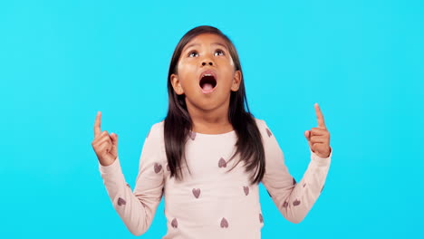 Pointing-up,-hands-and-wow-by-girl-child-in-studio