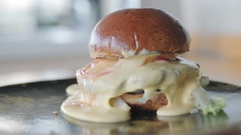 close-up of a gourmet cheeseburger with melting cheese