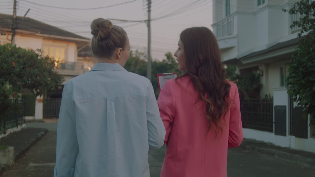 Two women walking through a neighborhood