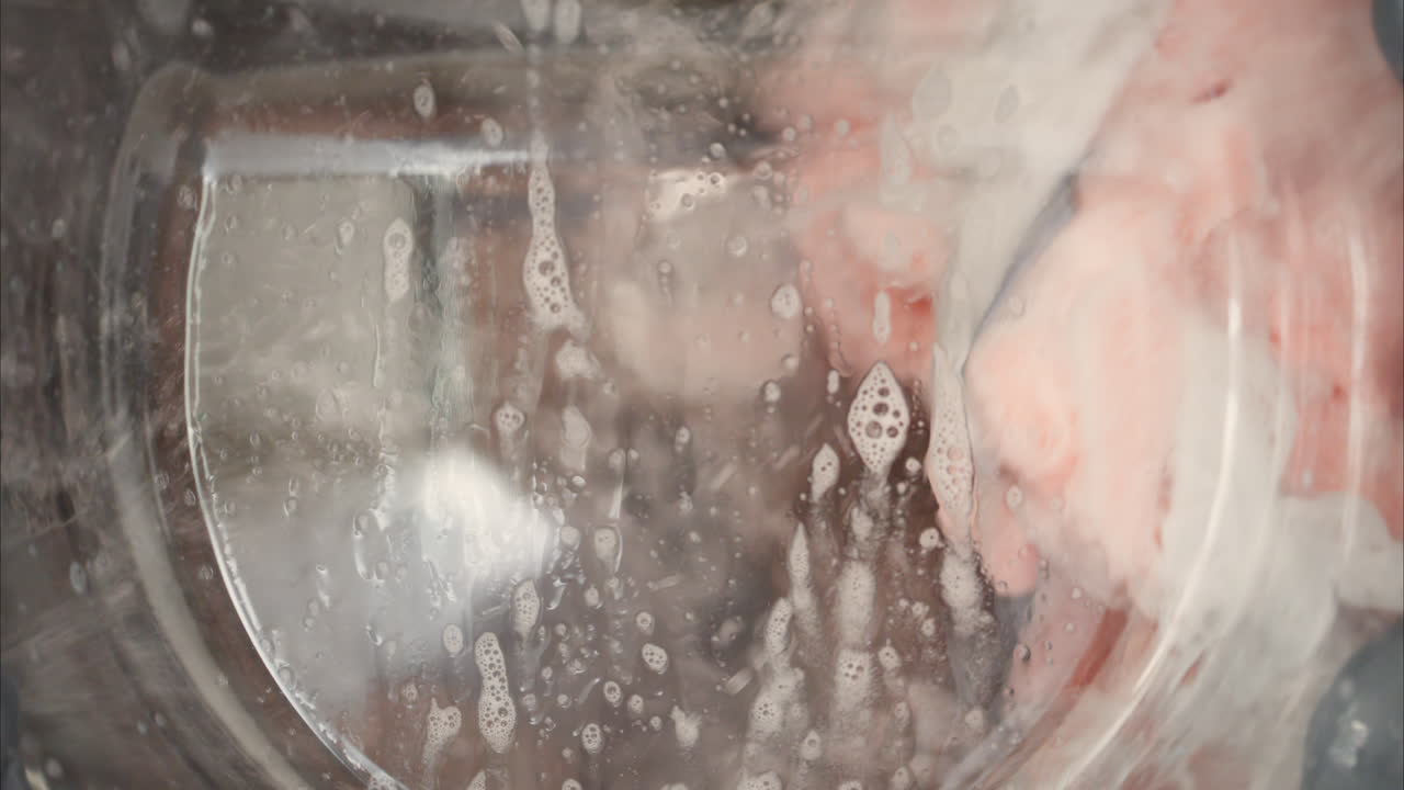 Close up of clothing being laundered in the washing machine
