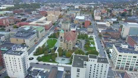 An-aerial-fly-over-PA,-Pennsylvania-downtown-on-a-summer-morning-focusing-on-church-in-the-middle