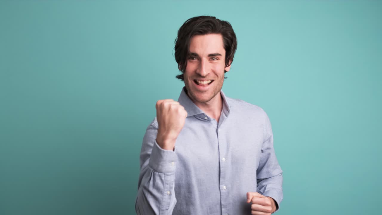 Stunned man with opened mouth in blue studio