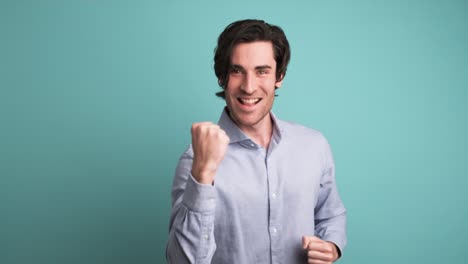 stunned man with opened mouth in blue studio