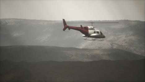 extreme slow motion flying helicopter near mountains with fog