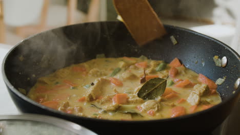 cooking delicious chicken curry in a wok