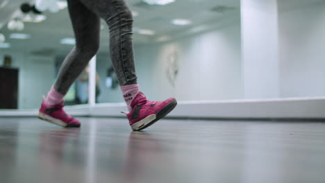 Close-up-leg-shot-of-a-dancer-performing-shuffle-footwork-in-a-dance-studio