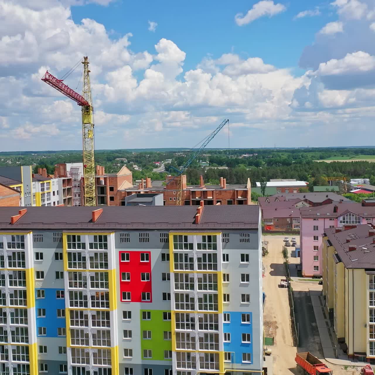 High crane works on building site. Aerial view of construction of multi storey apartment building