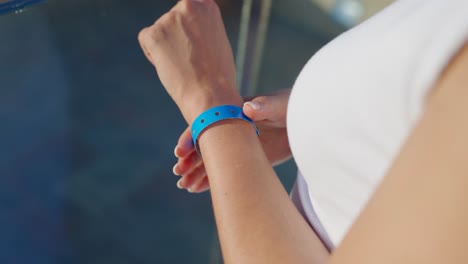 a woman's arm with a blue wristband