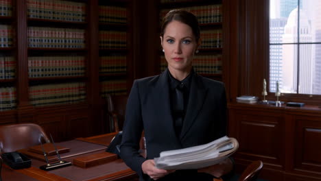 professional female lawyer in a law office holding documents