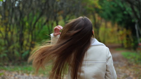 woman with coffee in a fall forest