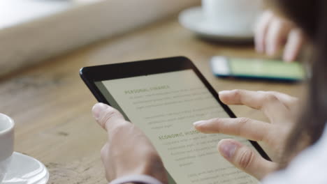 Woman-reading-tablet-with-business