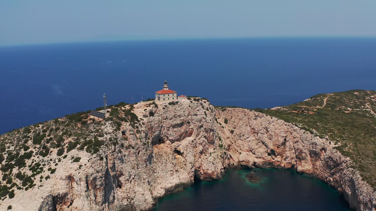 Lighthouse Over Steep Cliffs Of Susac Islands Off The Central Dalmatian Coast Of Croatia. Aerial Drone Shot