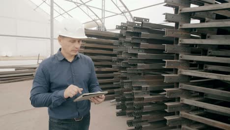 engineer inspecting metal beams in a warehouse
