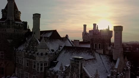 fresh snow on the towers and chimneys of an old castle, aerial push in