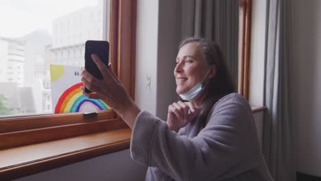 Woman-having-a-video-chat-on-her-smartphone-at-home