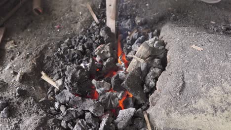 charcoal heating of cocunut knife for bending by indian blacksmith
