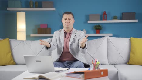 Home-office-worker-man-makes-a-trust-sign-to-the-camera.