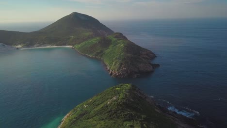 drone flies over breathtaking landscape in arraial do cabo with beautiful green hills and  wild coasts, brazil