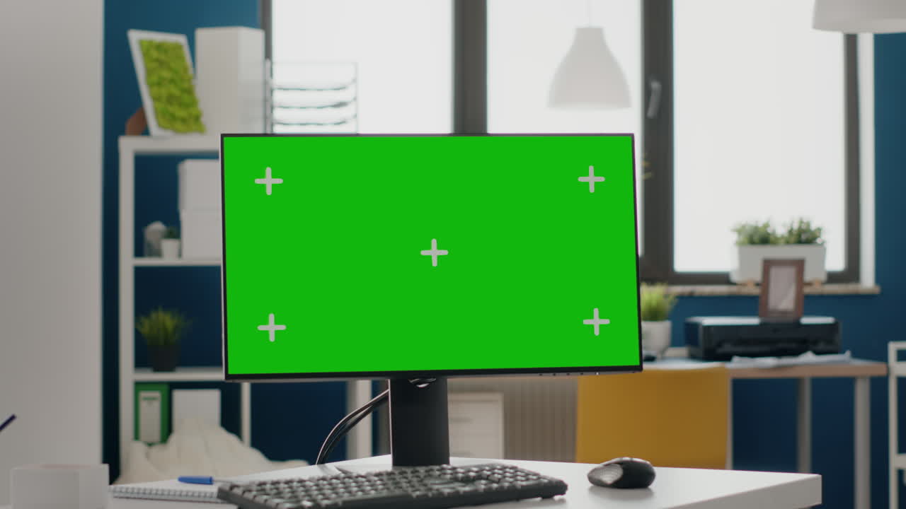 Close up of monitor with green screen at empty desk
