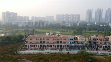 aerial drone shot capturing premium villas in noida india with the city skyline