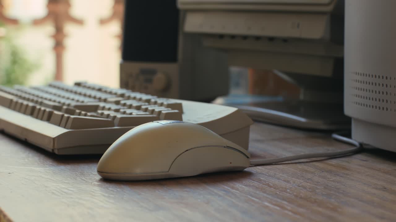 Man working and gaming on retro computer PC, IT engineer with vintage computer at home, using old fashion technology, close up of retro setup.