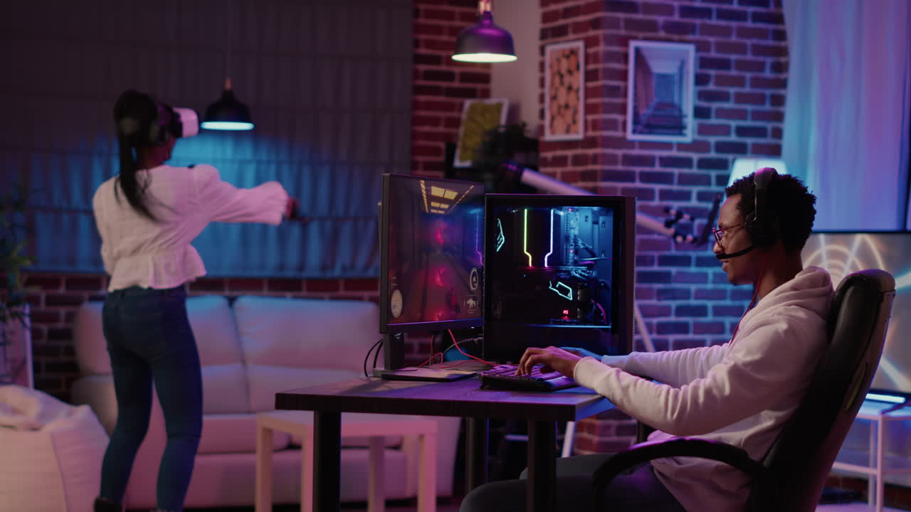 Gamer playing multiplayer first person shooter while gaming girl is fighting in virtual reality boxing