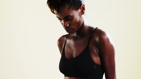 androgynous person in sportswear posing against white background