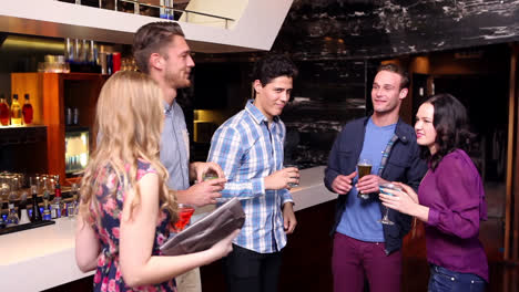 attractive friends dancing and drinking at the bar