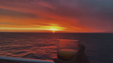 enjoying a drink during a stunning ocean sunset