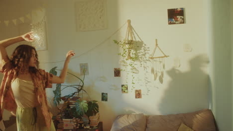 carefree girl dancing in cozy room filled with warm sunlight