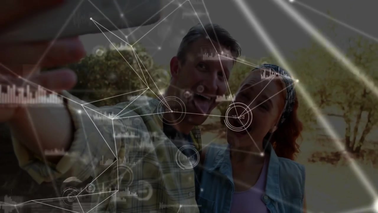 Man holding smartphone and woman taking selfie while tech nodes overlay densifying obscuring faces